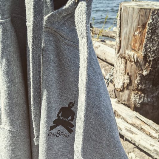 Cali8Fold gray hoodie hanging on dock in front of water
