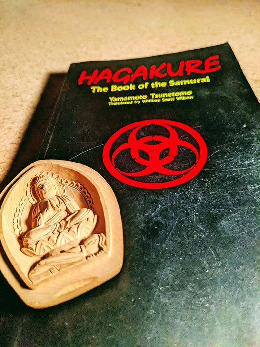 Hagakure book with a Medicine Buddha statue on cover