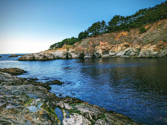 Cove with still water. Freediving location surrounded by rocky shore 