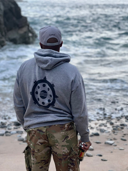 Freediver wearing Cali8Fold hoodie standing on the beach in Carmel