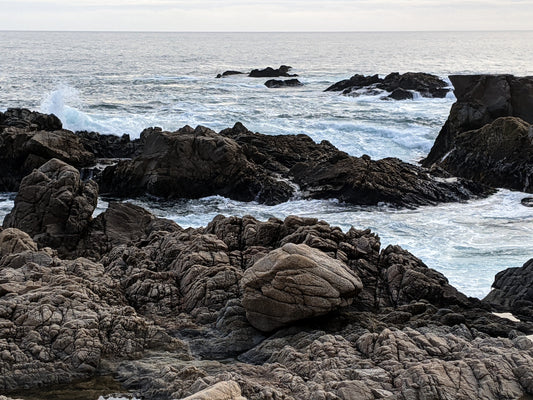 Freediving location in Carmel, California.  Rocky shore with waves crashing 