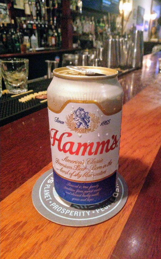 Hamms Beer. White, gold, blue and gold can on bar