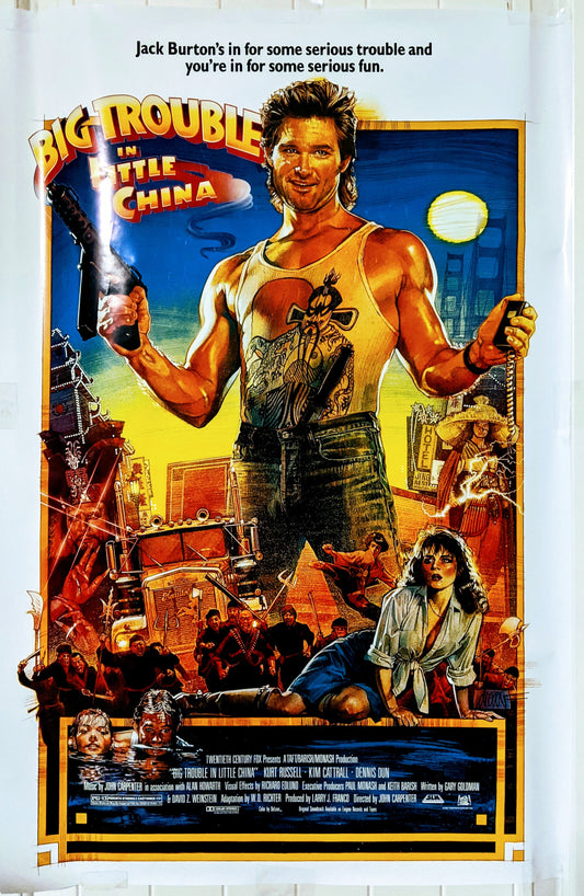 Movie poster of "Big Trouble in Little China", main character Jack Burton holding a grenade in left hand, machine gun in the other. Cali8Fold