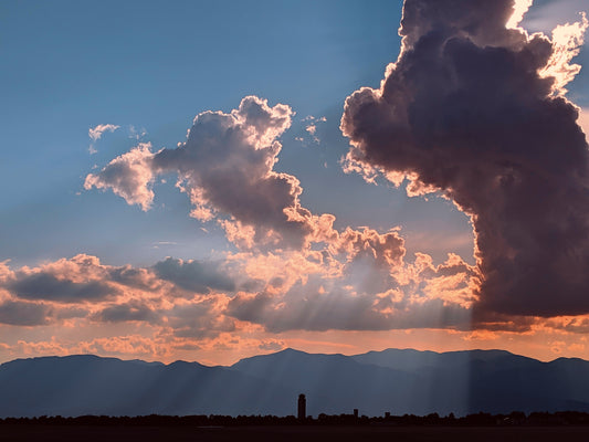 Sunrays shining through clouds, mountains in background