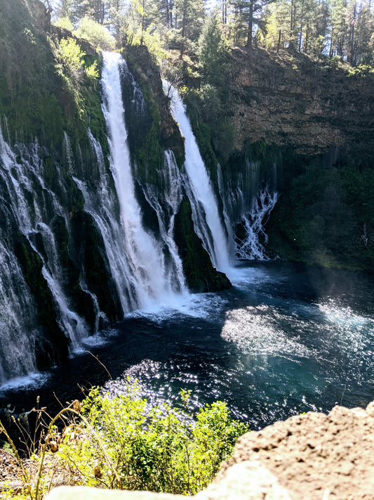 Several waterfalls going into pool of water for freedivers